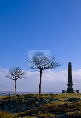 To use this stock image in your creative project, please select the size you need over to the right and click the "Add to Cart" button.
Your downloaded image will come with the Cutcaster watermark removed so don’t worry about the watermark you see on this page. War Monument and Trees on Horizon at Dawn stock photo, War Monument and Trees on Horizon at Dawn Bright Blue Sky by Robert Davies