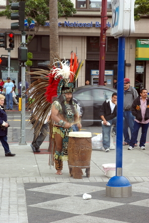 To use this stock image in your creative project, please select the size you need over to the right and click the "Add to Cart" button.
Your downloaded image will come with the Cutcaster watermark removed so don’t worry about the watermark you see on this page. Aztec Street Performer stock photo, An Aztec street performer in full ceremonial dress plays a drum for dancers on a street corner in San Francisco California. by Lynn Bendickson