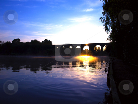 To use this stock image in your creative project, please select the size you need over to the right and click the "Add to Cart" button.
Your downloaded image will come with the Cutcaster watermark removed so don’t worry about the watermark you see on this page. Viaduct Bridge over Misty Lake at Dawn Sunset stock photo, Viaduct Bridge over Misty Lake at Dawn Sunset by Robert Davies