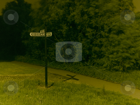 To use this stock image in your creative project, please select the size you need over to the right and click the "Add to Cart" button.
Your downloaded image will come with the Cutcaster watermark removed so don’t worry about the watermark you see on this page. Road Sign in Park at Night for Directions stock photo, Road Sign in Park at Night for Directions by Robert Davies