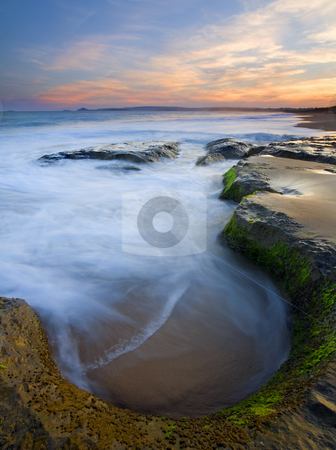 To use this stock image in your creative project, please select the size you need over to the right and click the "Add to Cart" button.
Your downloaded image will come with the Cutcaster watermark removed so don’t worry about the watermark you see on this page. Tidal Bowl stock photo, A bowl like depression in a stone shelf catches the incoming tide as the sun sets over Encounter Bay, South Australia. by Mike Dawson