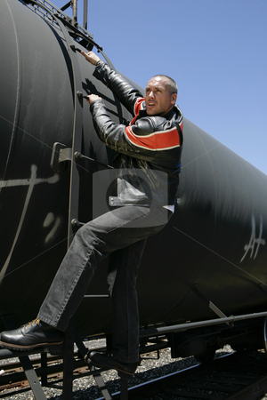To use this stock image in your creative project, please select the size you need over to the right and click the "Add to Cart" button.
Your downloaded image will come with the Cutcaster watermark removed so don’t worry about the watermark you see on this page. Man grabbing train stock photo, Male fashion model posing on train by Csaba Fikker
