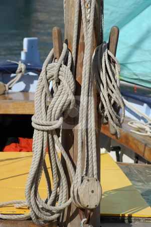 To use this stock image in your creative project, please select the size you need over to the right and click the "Add to Cart" button.
Your downloaded image will come with the Cutcaster watermark removed so don’t worry about the watermark you see on this page. Mast and Rope stock photo, Close-up of wooden tools and ropes of a boat by Serge VILLA