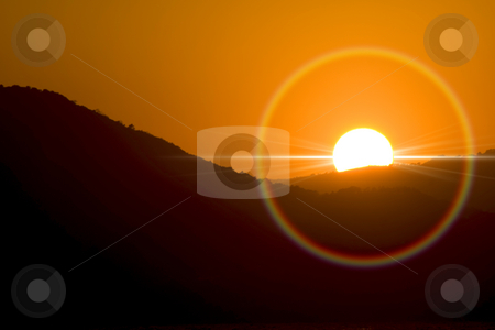To use this stock image in your creative project, please select the size you need over to the right and click the "Add to Cart" button.
Your downloaded image will come with the Cutcaster watermark removed so don’t worry about the watermark you see on this page. Sunset stock photo, Sunset and ray of sun rounded bty an halo. by Serge VILLA