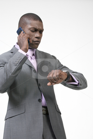 To use this stock image in your creative project, please select the size you need over to the right and click the "Add to Cart" button.
Your downloaded image will come with the Cutcaster watermark removed so don’t worry about the watermark you see on this page. Black Businessman checking watch stock photo, Black Businessman on his phone and checking his watch by Csaba Fikker