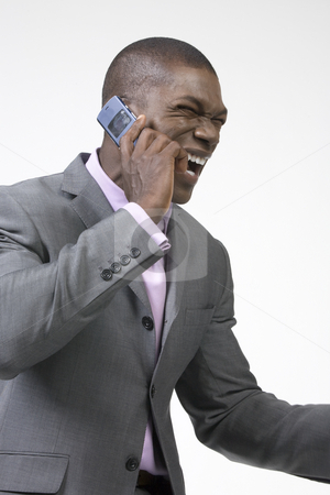 To use this stock image in your creative project, please select the size you need over to the right and click the "Add to Cart" button.
Your downloaded image will come with the Cutcaster watermark removed so don’t worry about the watermark you see on this page. African American Businessman laughing stock photo, Black Businessman laughing on the phone by Csaba Fikker
