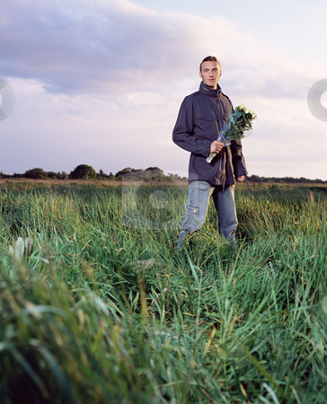To use this stock image in your creative project, please select the size you need over to the right and click the "Add to Cart" button.
Your downloaded image will come with the Cutcaster watermark removed so don’t worry about the watermark you see on this page. MPIXIS900776 stock photo, Man in a field holding a bunch of roses by Mpixis World