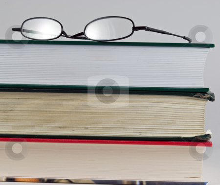 To use this stock image in your creative project, please select the size you need over to the right and click the "Add to Cart" button.
Your downloaded image will come with the Cutcaster watermark removed so don’t worry about the watermark you see on this page. Knowledge is power stock photo, Books stacked on top of each other with glasses by Robert Cabrera