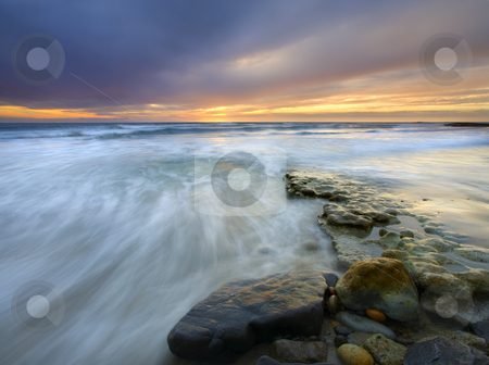 To use this stock image in your creative project, please select the size you need over to the right and click the "Add to Cart" button.
Your downloaded image will come with the Cutcaster watermark removed so don’t worry about the watermark you see on this page. Driven before the storm stock photo, Rolling waves driven onto this rocky shore by a storm looming on the horizon as the sun sets over the coast of California near San Deigo by Mike Dawson