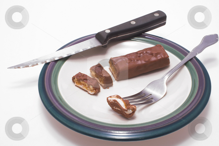 To use this stock image in your creative project, please select the size you need over to the right and click the "Add to Cart" button.
Your downloaded image will come with the Cutcaster watermark removed so don’t worry about the watermark you see on this page. Chocolate Candy Bar stock photo, A chocolate candy bar being sliced in a plate. by Robert Byron