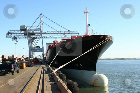 To use this stock image in your creative project, please select the size you need over to the right and click the "Add to Cart" button.
Your downloaded image will come with the Cutcaster watermark removed so don’t worry about the watermark you see on this page. Container ship being loaded stock photo, Dock cranes loading a container ship by Claude Beaubien