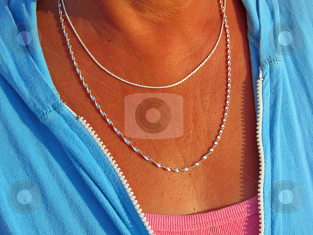 To use this stock image in your creative project, please select the size you need over to the right and click the "Add to Cart" button.
Your downloaded image will come with the Cutcaster watermark removed so don’t worry about the watermark you see on this page. Silver Necklace Duo stock photo, Two silver necklaces adorn the neck of a tanned middle aged woman by Jeff Clow