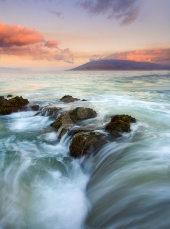 To use this stock image in your creative project, please select the size you need over to the right and click the "Add to Cart" button.
Your downloaded image will come with the Cutcaster watermark removed so don’t worry about the watermark you see on this page. Sunrise Drain stock photo, A colorful sunrise illuminates the clouds over the West Maui Mountains as the tides ebb over a lava rock shelf creating the impression the ocean is draining before my eyes. by Mike Dawson