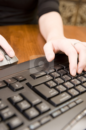 To use this stock image in your creative project, please select the size you need over to the right and click the "Add to Cart" button.
Your downloaded image will come with the Cutcaster watermark removed so don’t worry about the watermark you see on this page. Woman working on PC keyboard and mouse. stock photo, Female executive working on a PC keyboard and/or mouse on a wooden desk. by Nicolaas Traut