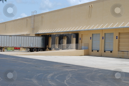 To use this stock image in your creative project, please select the size you need over to the right and click the "Add to Cart" button.
Your downloaded image will come with the Cutcaster watermark removed so don’t worry about the watermark you see on this page. Loading Docks stock photo, Warehouse loading docks with trailer by Robert Cabrera