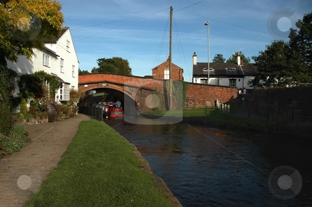 To use this stock image in your creative project, please select the size you need over to the right and click the "Add to Cart" button.
Your downloaded image will come with the Cutcaster watermark removed so don’t worry about the watermark you see on this page. Bridgewater Canal Lymm stock photo, Located in Cheshire, small town dating back to 15th Century. by Ray Roscoe