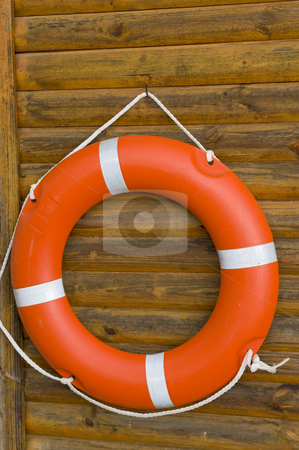 To use this stock image in your creative project, please select the size you need over to the right and click the "Add to Cart" button.
Your downloaded image will come with the Cutcaster watermark removed so don’t worry about the watermark you see on this page. Lifebuoy hanging on a wooden wall stock photo, A bright orange lifebuoy hanging on a wooden wall at a swimming pool. by Nicolaas Traut