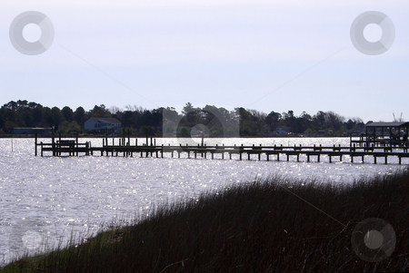 To use this stock image in your creative project, please select the size you need over to the right and click the "Add to Cart" button.
Your downloaded image will come with the Cutcaster watermark removed so don’t worry about the watermark you see on this page. Fishing Pier or Boat Dock stock photo, A fishing pier and / or boat dock. by Robert Byron