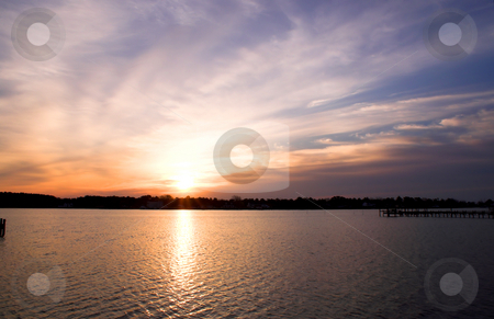 To use this stock image in your creative project, please select the size you need over to the right and click the "Add to Cart" button.
Your downloaded image will come with the Cutcaster watermark removed so don’t worry about the watermark you see on this page. Ocean Sunrise or Sunset stock photo, The sunrise or sunset over a salt water inlet. by Robert Byron