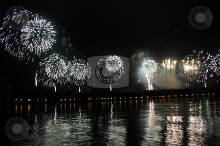 To use this stock image in your creative project, please select the size you need over to the right and click the "Add to Cart" button.
Your downloaded image will come with the Cutcaster watermark removed so don’t worry about the watermark you see on this page. Fireworks stock photo, Long line of white or silver fireworks with reflections in a lake. by Lucy Clark
