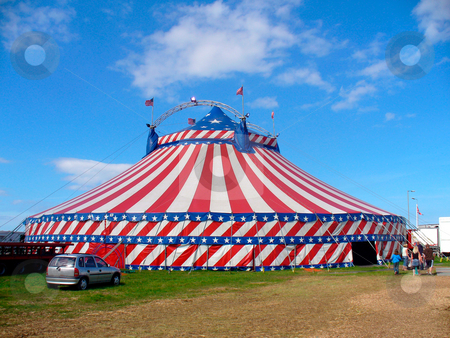 To use this stock image in your creative project, please select the size you need over to the right and click the "Add to Cart" button.
Your downloaded image will come with the Cutcaster watermark removed so don’t worry about the watermark you see on this page. Day out at the circus stock photo, Circus big top tent in field decorated with stars and stripes. by Martin Crowdy