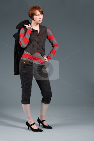 To use this stock image in your creative project, please select the size you need over to the right and click the "Add to Cart" button.
Your downloaded image will come with the Cutcaster watermark removed so don’t worry about the watermark you see on this page. Fashion standing stock photo, Young red haired girl with a fashion attitude by Frenk and Danielle Kaufmann