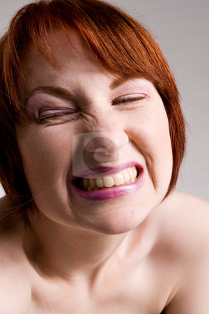 To use this stock image in your creative project, please select the size you need over to the right and click the "Add to Cart" button.
Your downloaded image will come with the Cutcaster watermark removed so don’t worry about the watermark you see on this page. Emotive smiling face stock photo, Red haired girl with emotive faces and expressions by Frenk and Danielle Kaufmann