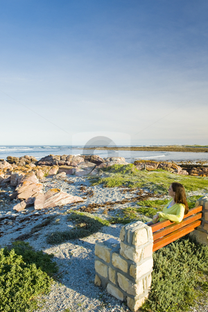 To use this stock image in your creative project, please select the size you need over to the right and click the "Add to Cart" button.
Your downloaded image will come with the Cutcaster watermark removed so don’t worry about the watermark you see on this page. Lady sitting on a bench ovelooking the sea stock photo, A lady sitting by herself on wooden bench looking at the sea. by Nicolaas Traut