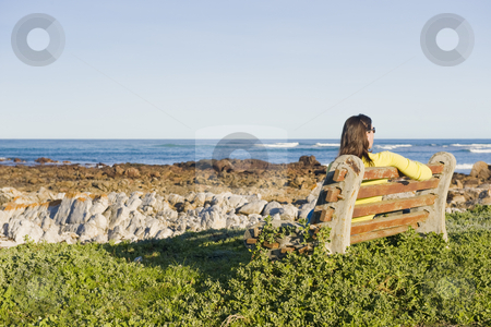 To use this stock image in your creative project, please select the size you need over to the right and click the "Add to Cart" button.
Your downloaded image will come with the Cutcaster watermark removed so don’t worry about the watermark you see on this page. Lady sitting on a bench ovelooking the sea stock photo, A lady sitting by herself on wooden bench looking at the sea. by Nicolaas Traut