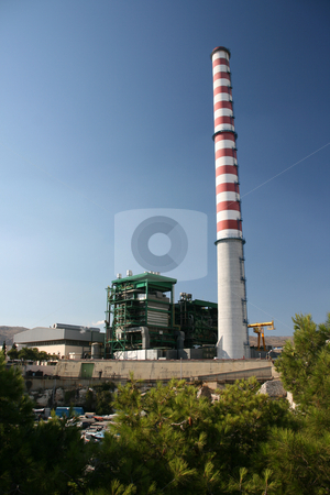 To use this stock image in your creative project, please select the size you need over to the right and click the "Add to Cart" button.
Your downloaded image will come with the Cutcaster watermark removed so don’t worry about the watermark you see on this page. Power plant stock photo, Steam electric power plant with high red and white chimney at piraeus athens greece by EVANGELOS THOMAIDIS