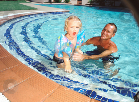 To use this stock image in your creative project, please select the size you need over to the right and click the "Add to Cart" button.
Your downloaded image will come with the Cutcaster watermark removed so don’t worry about the watermark you see on this page. Adult and child in pool stock photo, Adult and child in pool by Mpixis World