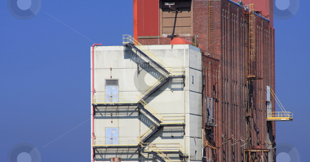 To use this stock image in your creative project, please select the size you need over to the right and click the "Add to Cart" button.
Your downloaded image will come with the Cutcaster watermark removed so don’t worry about the watermark you see on this page. Industrial Paper Mill Buildings stock photo, Brick and white buildings on a blue sky background. Part of a pulp and paper mill that is being dismantled. by Steve Stedman
