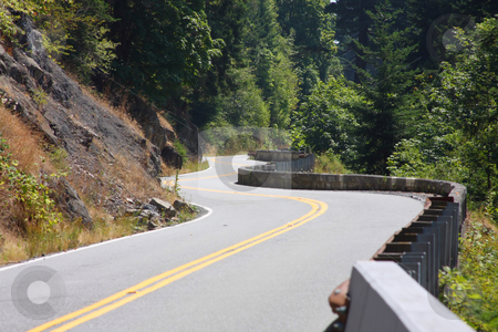 To use this stock image in your creative project, please select the size you need over to the right and click the "Add to Cart" button.
Your downloaded image will come with the Cutcaster watermark removed so don’t worry about the watermark you see on this page. Hillside Winding Road stock photo, Winding road along a cliff through the forest. by Steve Stedman