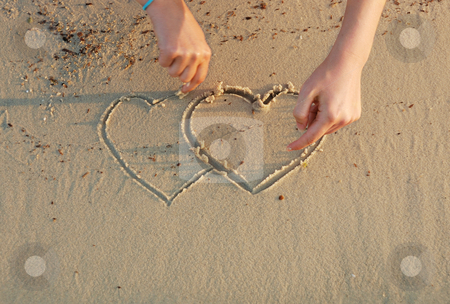 To use this stock image in your creative project, please select the size you need over to the right and click the "Add to Cart" button.
Your downloaded image will come with the Cutcaster watermark removed so don’t worry about the watermark you see on this page. Hearts in a sand stock photo, A girl is drawing hearts in a sand by Ivan Paunovic
