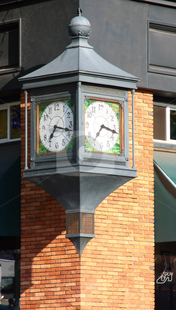 To use this stock image in your creative project, please select the size you need over to the right and click the "Add to Cart" button.
Your downloaded image will come with the Cutcaster watermark removed so don’t worry about the watermark you see on this page. Street Corner Clock stock photo, A large clock on a street corner attached to a brick building. by Steve Stedman