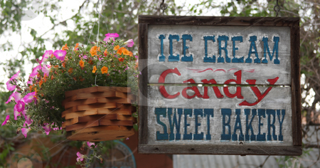 To use this stock image in your creative project, please select the size you need over to the right and click the "Add to Cart" button.
Your downloaded image will come with the Cutcaster watermark removed so don’t worry about the watermark you see on this page. Ice Cream, Candy And Sweets stock photo, Ice Cream Candy and Sweet Bakery Sign with Flowers by Steve Stedman