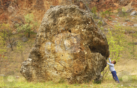 To use this stock image in your creative project, please select the size you need over to the right and click the "Add to Cart" button.
Your downloaded image will come with the Cutcaster watermark removed so don’t worry about the watermark you see on this page. Boy supporting a rock stock photo, A boy is supporting a rock with his hands by Ivan Paunovic