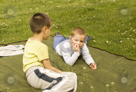 To use this stock image in your creative project, please select the size you need over to the right and click the "Add to Cart" button.
Your downloaded image will come with the Cutcaster watermark removed so don’t worry about the watermark you see on this page. Springtime stock photo, Two boys on a blanket enjoying the sunny day by Ivan Paunovic