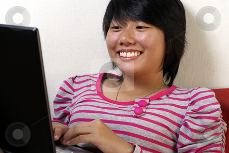 To use this stock image in your creative project, please select the size you need over to the right and click the "Add to Cart" button.
Your downloaded image will come with the Cutcaster watermark removed so don’t worry about the watermark you see on this page. Happy asian lady using laptop stock photo, Happy young asian lady on laptop. by Wong Chee Yen