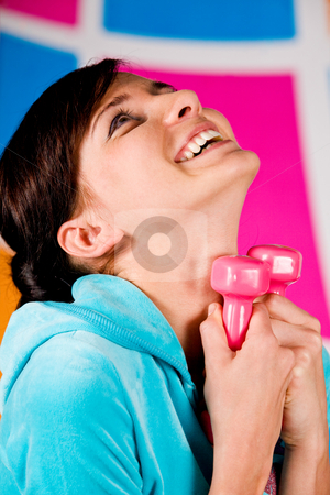 To use this stock image in your creative project, please select the size you need over to the right and click the "Add to Cart" button.
Your downloaded image will come with the Cutcaster watermark removed so don’t worry about the watermark you see on this page. I Like Fitness stock photo, Beautiful young woman curls dumbbells with a happy smile by Vitaly Sokolovskiy