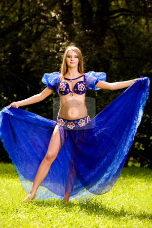 To use this stock image in your creative project, please select the size you need over to the right and click the "Add to Cart" button.
Your downloaded image will come with the Cutcaster watermark removed so don’t worry about the watermark you see on this page. Belly Dancer in Blue stock photo, Lovely young woman dancing belly dance in blue outdoors by Vitaly Sokolovskiy