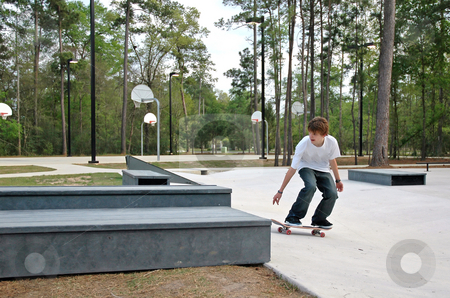 To use this stock image in your creative project, please select the size you need over to the right and click the "Add to Cart" button.
Your downloaded image will come with the Cutcaster watermark removed so don’t worry about the watermark you see on this page. Teen Skater at the Park stock photo, A teen skater gets ready to do a trick at a suburban park by Jeff Clow