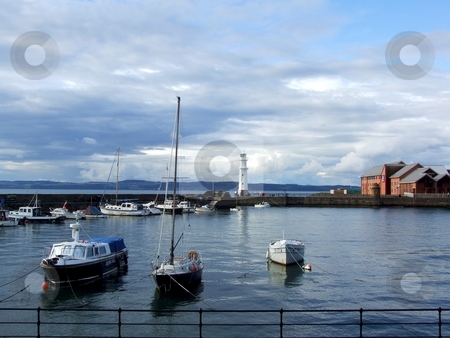 To use this stock image in your creative project, please select the size you need over to the right and click the "Add to Cart" button.
Your downloaded image will come with the Cutcaster watermark removed so don’t worry about the watermark you see on this page. Edinburgh stock photo, Boats and lighthouse in the harbour, Edinburgh by Juliet Photography