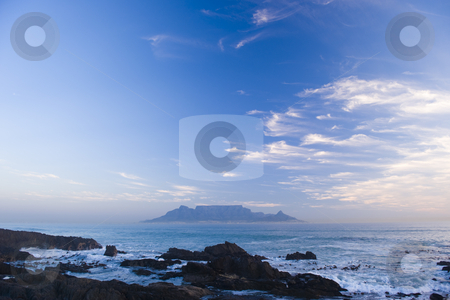 To use this stock image in your creative project, please select the size you need over to the right and click the "Add to Cart" button.
Your downloaded image will come with the Cutcaster watermark removed so don’t worry about the watermark you see on this page. Table mountain Cape Town stock photo, Table Mountain - the world famous landmark in Cape Town, South Africa. Picture taken on a clear Winters day from the Blouberg Strand beach. A vivid blue sky looks spectacular behind clouds in the sunset. by Nicolaas Traut