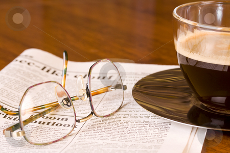 To use this stock image in your creative project, please select the size you need over to the right and click the "Add to Cart" button.
Your downloaded image will come with the Cutcaster watermark removed so don’t worry about the watermark you see on this page. Coffee newspaper and reading glasses stock photo, Freshly brewed coffee on a newspaper with reading glasses on wooden desk by Magdalena Ascough