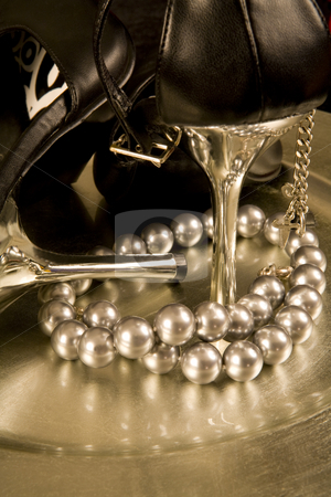 To use this stock image in your creative project, please select the size you need over to the right and click the "Add to Cart" button.
Your downloaded image will come with the Cutcaster watermark removed so don’t worry about the watermark you see on this page. Stilettos and a string of pearls on a tray stock photo, Closeup of black stilettos with silver heels and a string of pearls on a silver tray by Magdalena Ascough