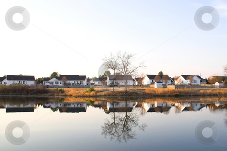To use this stock image in your creative project, please select the size you need over to the right and click the "Add to Cart" button.
Your downloaded image will come with the Cutcaster watermark removed so don’t worry about the watermark you see on this page. Lake Houses stock photo, A neighborhood of houses on a lake. by Robert Byron