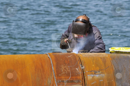 To use this stock image in your creative project, please select the size you need over to the right and click the "Add to Cart" button.
Your downloaded image will come with the Cutcaster watermark removed so don’t worry about the watermark you see on this page. Man welding stock photo, Worker welding two big pipes in a harbour by Massimiliano Leban