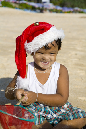 To use this stock image in your creative project, please select the size you need over to the right and click the "Add to Cart" button.
Your downloaded image will come with the Cutcaster watermark removed so don’t worry about the watermark you see on this page. Boy with Christmas hat on beach stock photo, Little Thai boy playing and with Christmas hat on a beach by Magdalena Ascough