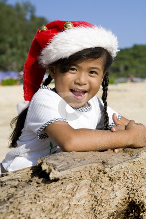 To use this stock image in your creative project, please select the size you need over to the right and click the "Add to Cart" button.
Your downloaded image will come with the Cutcaster watermark removed so don’t worry about the watermark you see on this page. Thai girl with Christmas hat on beach stock photo, Little Thai girl with Christmas hat on a beach by Magdalena Ascough